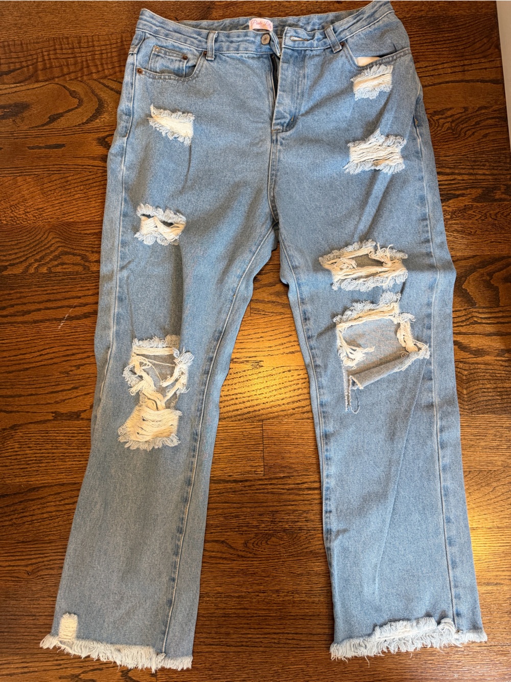 Pink lily ripped jeans with frayed bottoms